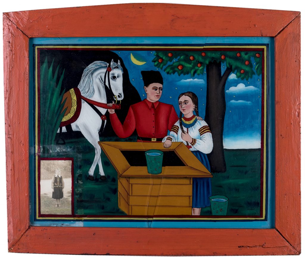 Obraz przedstawia ubraną w tradycyjny ukraiński strój dziewczynę i kozaka trzymającego lejce konia. W centrum obrazka studnia,w tle księżyc. W donym rogu obrazu zdjęcie kobiety w ludowym stroju ukraińskim.